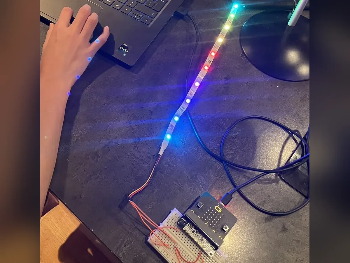 A glowing rainbow LED strip connected to a Micro:bit
